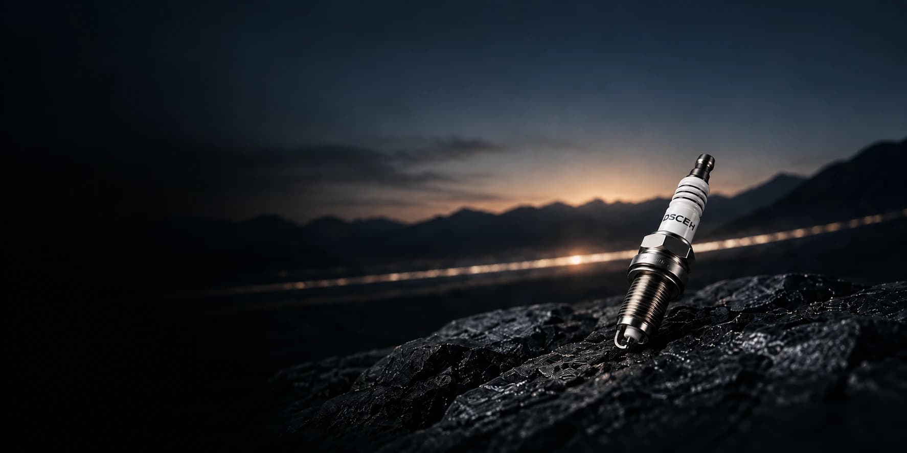 DSCEH spark plug on dark rock against a mountain horizon — concept visual